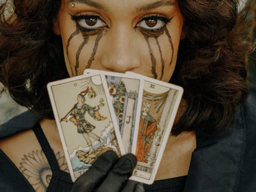 woman with creepy makeup holding tarot cards