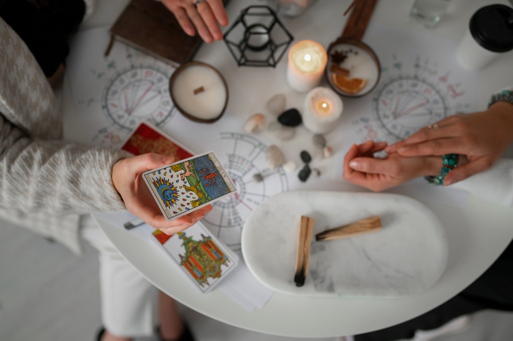 Top view woman reading tarot at home
